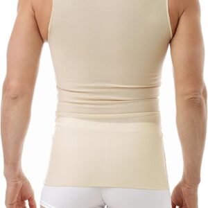 A man is pictured from behind, wearing a beige tank top and white fitted shorts. The tank top, possibly a transmasc binder, is form-fitting and tucks into the shorts. He has short hair and a muscular build.