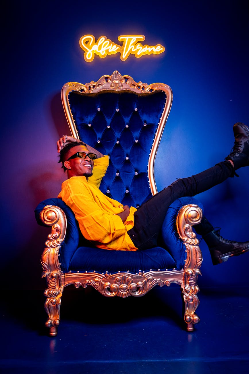 man sitting on blue sofa chair