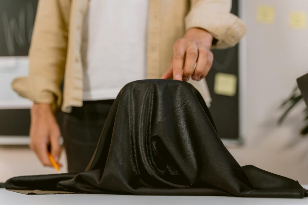 hand of a person holding a black cloth