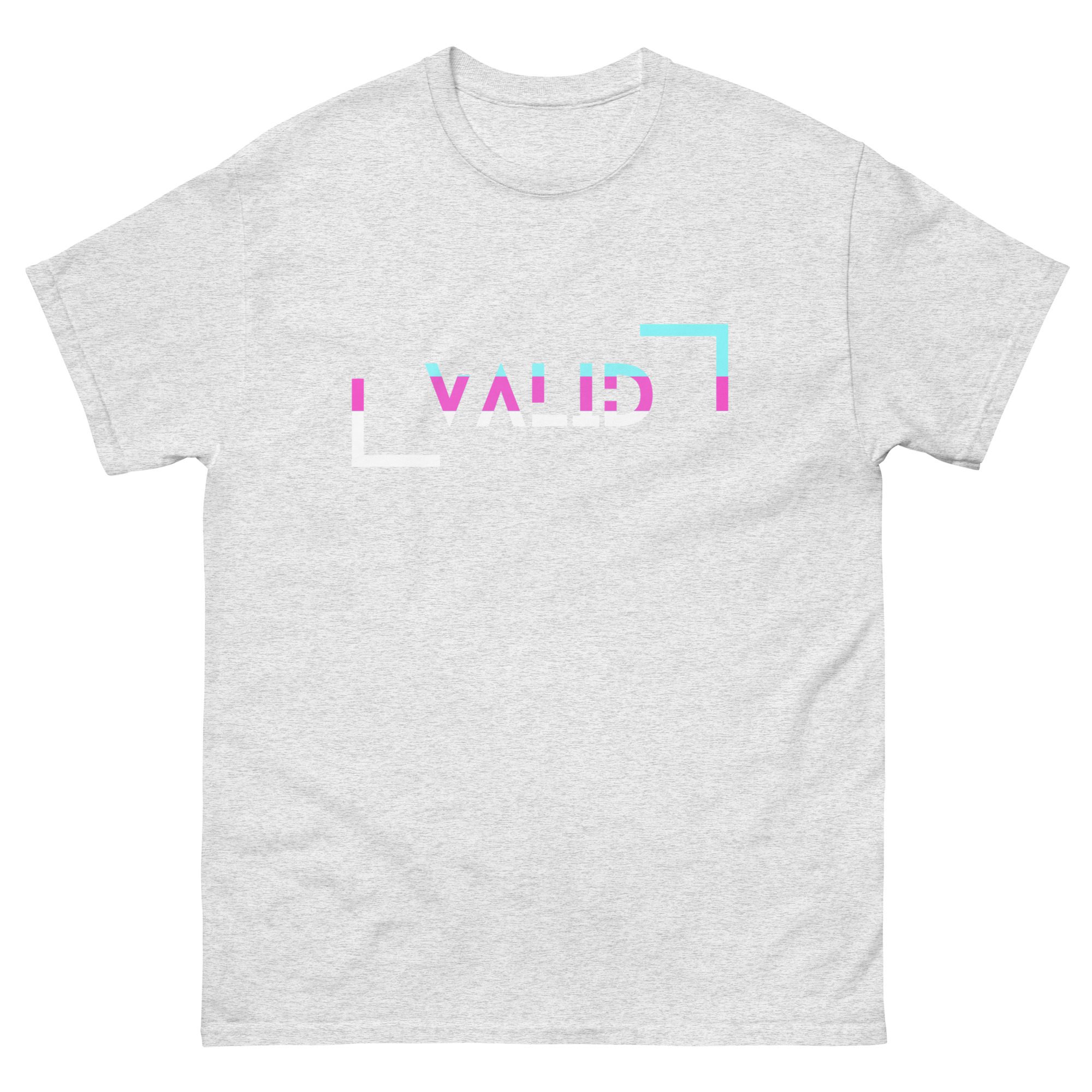 A heather gray unisex classic tee featuring the word "WILD" in a distorted, glitch-style font with blue, pink, and white rectangular accents around the text.