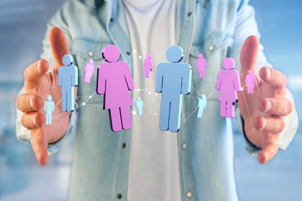 man woman A person holding digital icons of men and women connected by lines, symbolizing networking, gender diversity, or teamwork in science, with a blurred background.
