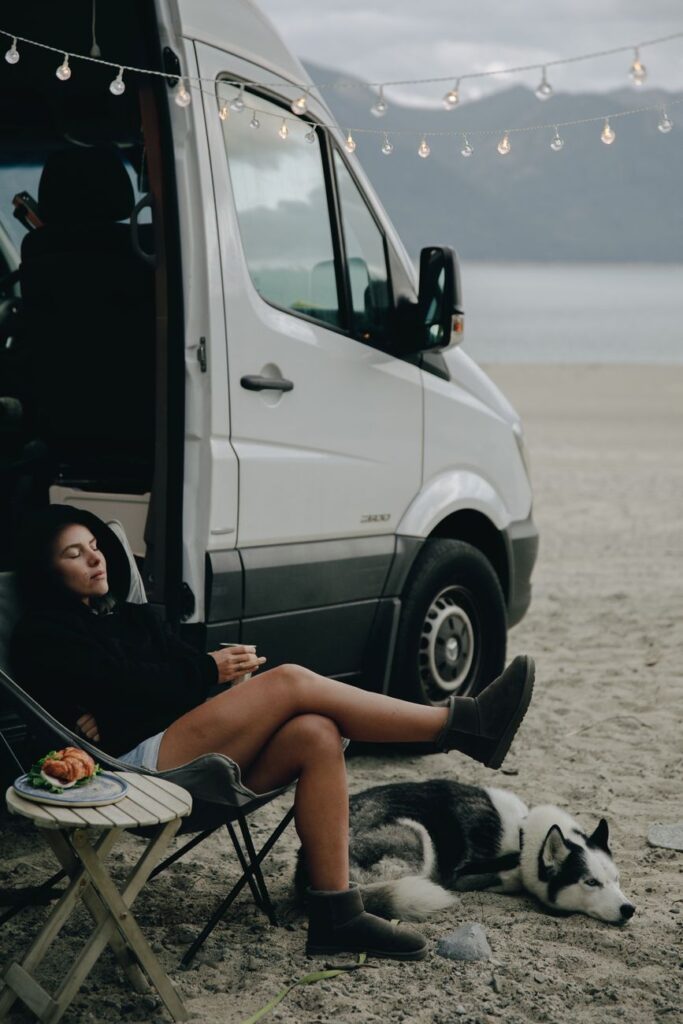 a woman living a van life with her dog