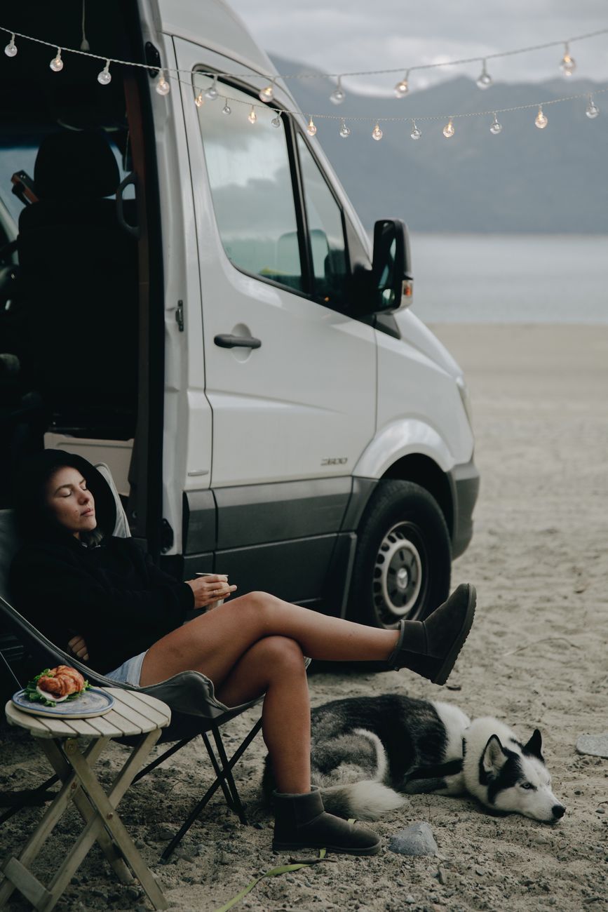 a woman living a van life with her dog