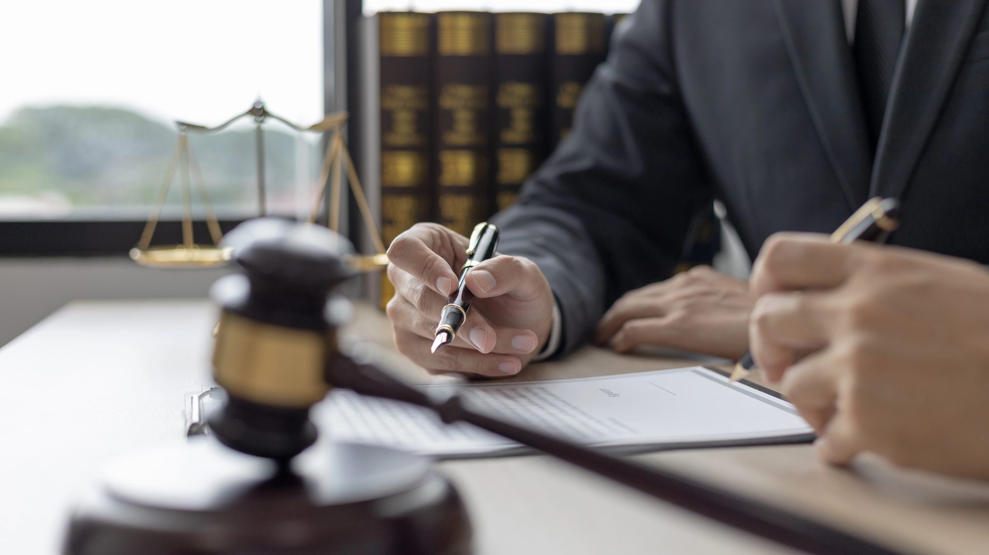 Legal forms, identification documents, and a pen arranged on a desk