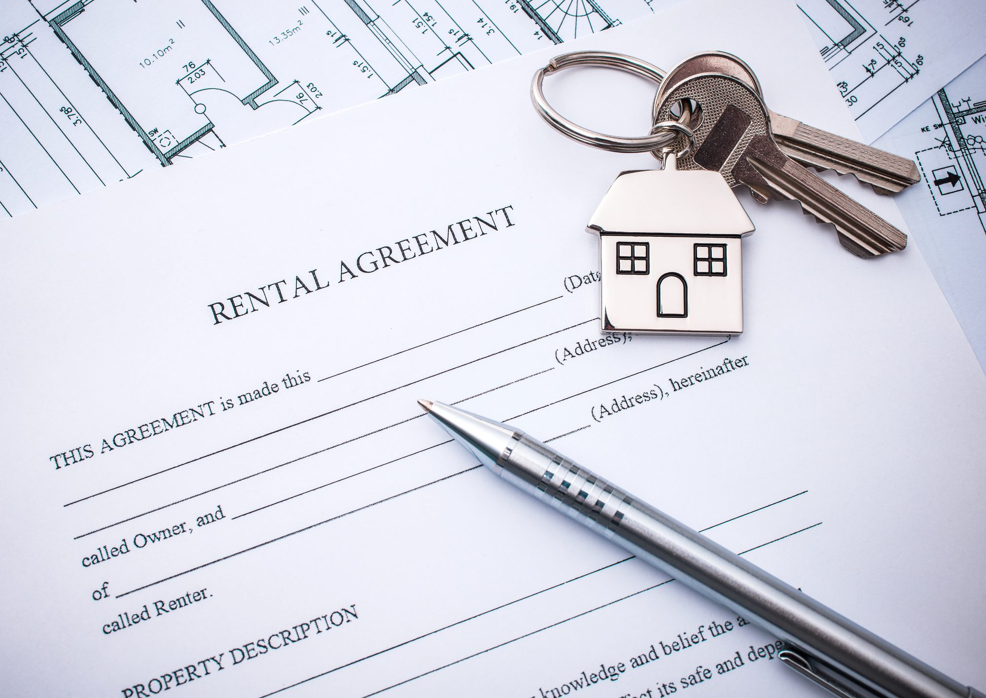 Apartment keys resting on rental paperwork