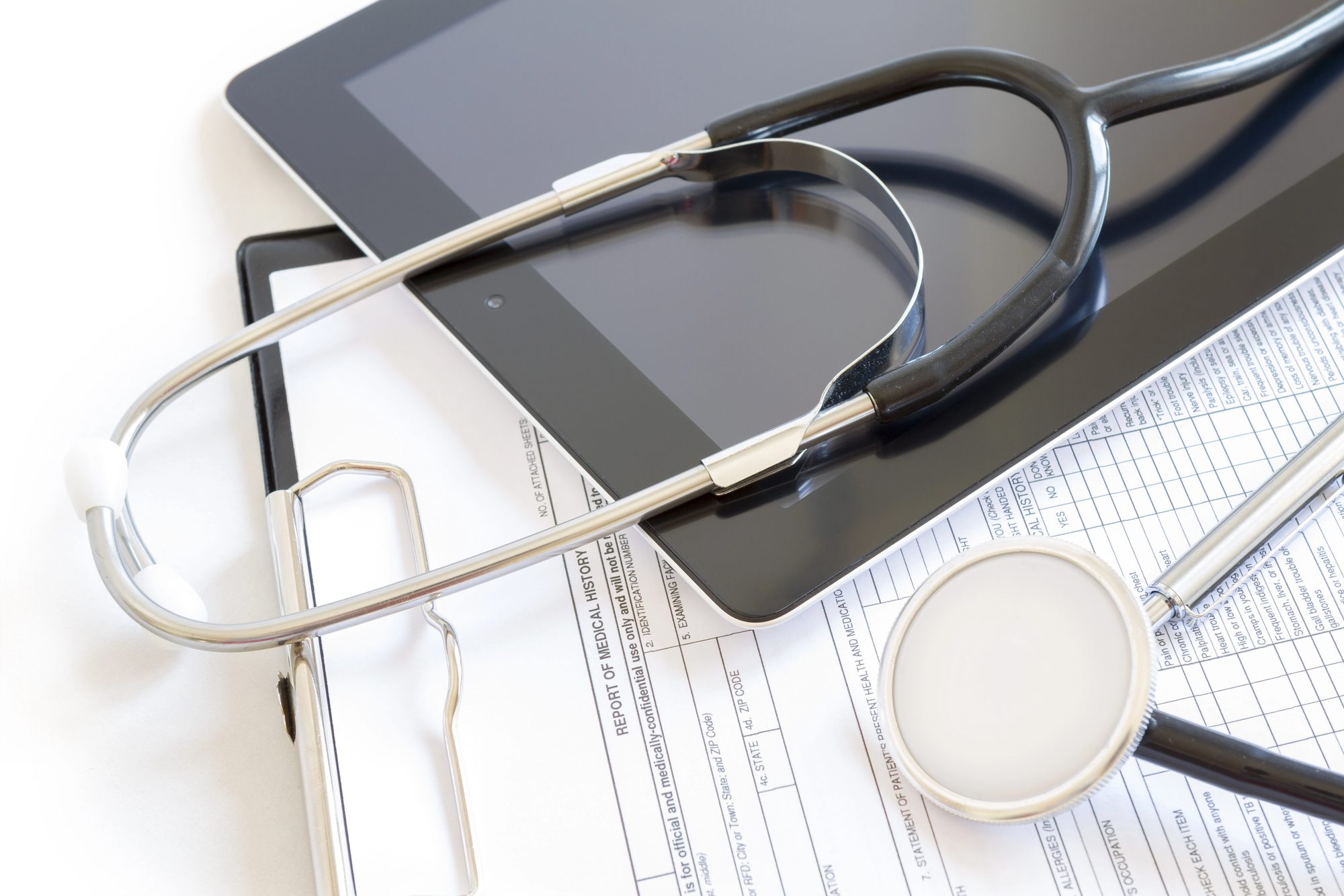 Healthcare and insurance paperwork beside a stethoscope