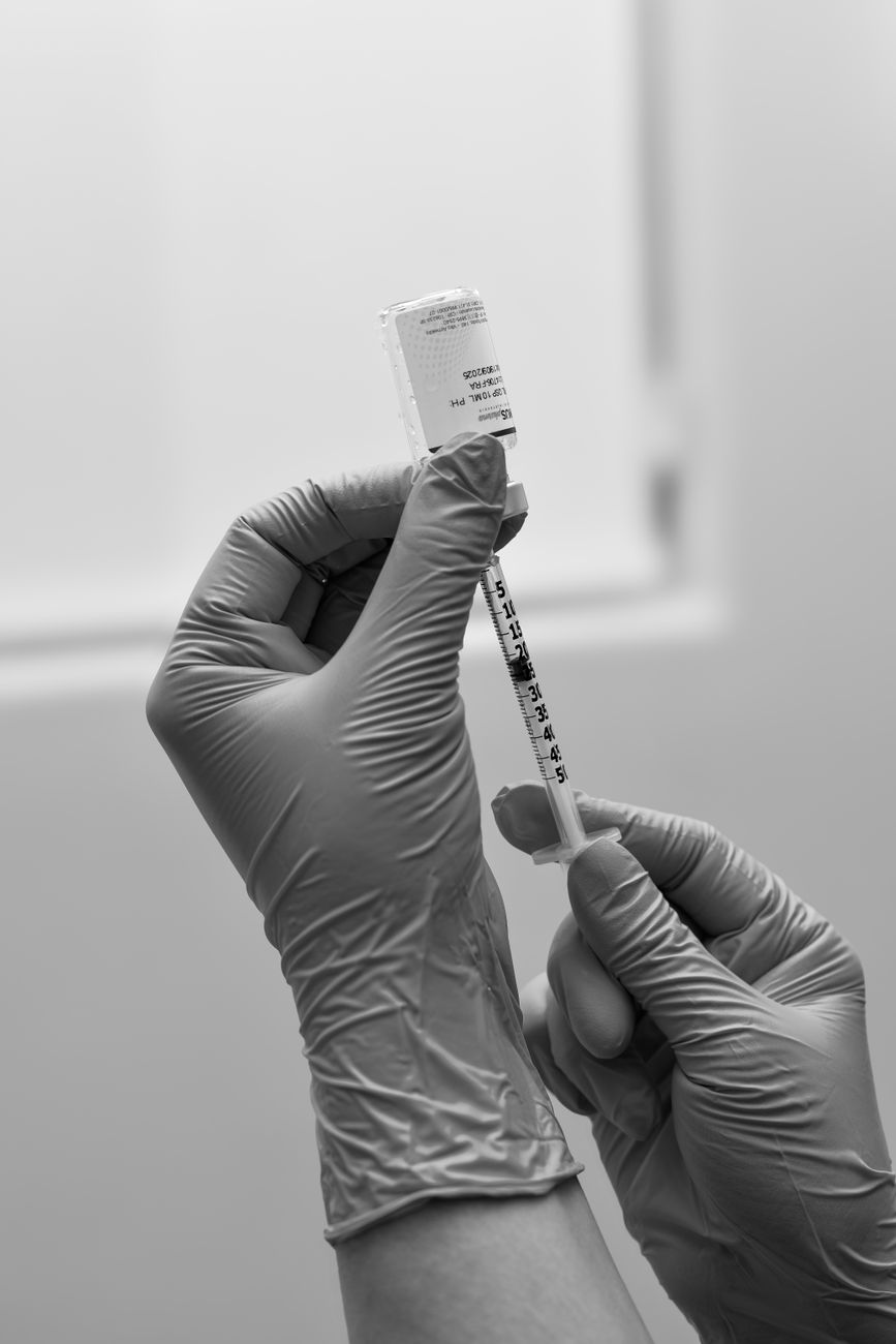 medical professional preparing vaccine injection