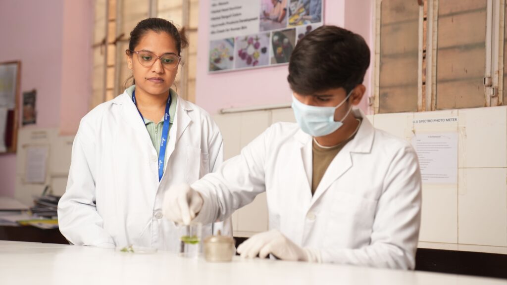pexels-photo-37765899-37765899 Two young scientists in lab coats performing an experiment in a laboratory setting.
